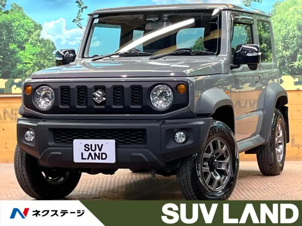 Suzuki Jimny Sierra 1.5 JC 4WD with Factory 8-inch Navigation, Full-Seg TV, Backup Camera, Safety Support, Cruise Control, Corner Sensors, Downhill Assist, LED Headlights, Seat Heaters, ETC, Factory 15-inch Alloy Wheels, Idling Stop (Medium Gray) — thumbnail 1