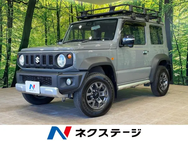 Suzuki Jimny Sierra 1.5 JC 4WD with Genuine Navigation, Backup Camera, Cold Climate Spec, Collision Mitigation System, AC 100V, Non-Smoking Car, Water-Repellent Seats, Seat Heaters, Smart Key, LED Headlights, ETC, Cruise Control, Lane Departure Warning, Misacceleration Mitigation (Medium Gray)
