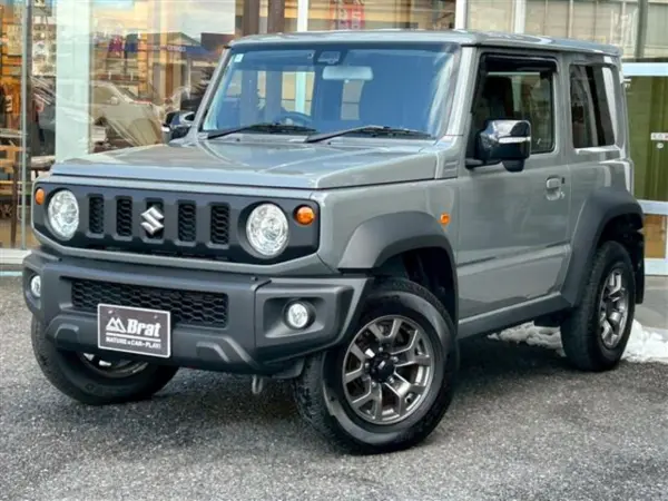 Suzuki Jimny Sierra 1.5 JC 4WD Safety Support 4WD Mirror Heater Cruise Control Genuine Navi (TV DVD Bluetooth) Backup Monitor Push Start Lane Keep Assist Anti-Skid System Automatic High Beam (Gray Metallic) — thumbnail 1