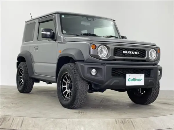 Suzuki Jimny Sierra 1.5 JC 4WD with Genuine 8-inch Navi, Backup Camera, Seat Heater, LED Headlights, Built-in ETC, Drive Recorder, Aftermarket 16-inch Alloy Wheels, Block Tires, Suzuki Logo Grille, Cruise Control (Gray Metallic) — thumbnail 1